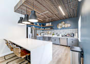 Thumbnail 23 of 39 - Kitchen in the clubhouse at Woods of Fairfax, featuring kitchen appliances and countertops.