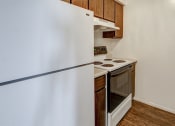 Thumbnail 2 of 25 - Apartment Kitchen at The Woods of Eagle Creek with white appliances