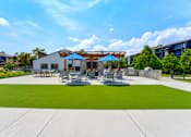 Thumbnail 32 of 39 - Outdoor seating and grills at Woods of Fairfax, providing residents with comfortable spaces for dining and relaxation.