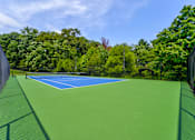 Thumbnail 28 of 39 - Tennis court at Woods of Fairfax, featuring a well-maintained playing surface.