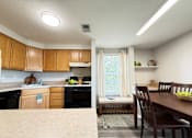 Thumbnail 2 of 17 - Kitchen and Dining Room with Built in Desk at Ashmore Trace
