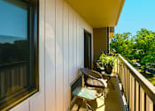 Thumbnail 5 of 9 - Balcony of a one-bedroom apartment at Village Square Apartments with a view of the surrounding area.