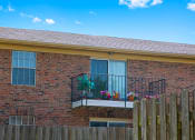 Thumbnail 11 of 16 - Balcony at Cambridge Square Apartments in Greenwood, with views of the surrounding landscape.
