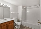 Thumbnail 6 of 24 - Bathroom with a toilet, sink, and tub in a 2-bedroom, 1-bath apartment at Briarwood Apartments Columbus.