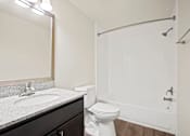 Thumbnail 7 of 15 - Bathroom featuring a toilet, sink, and bathtub in a 2-bedroom, 1-bath apartment at Cambridge Square Apartments in Flint.