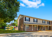 Thumbnail 15 of 16 - Exterior view of Cambridge Square Apartments in Greenwood, showcasing landscaped grounds.