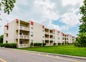 Thumbnail 14 of 16 - Building exterior at Cambridge Square Apartments in Lauderdale Lakes, featuring balconies and well-maintained landscaping.