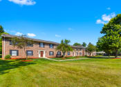 Thumbnail 9 of 16 - Exterior view of Cambridge Square Apartments in Greenwood, with well-maintained landscaping, and a welcoming entrance.