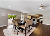 Thumbnail 18 of 24 - Clubhouse dining area and kitchen at Briarwood Apartments, Columbus, IN, featuring a spacious and inviting space for residents.