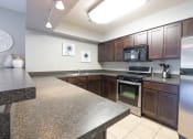 Thumbnail 15 of 24 - Clubhouse Kitchen with stainless steel appliances at Brairwood Apartments, Columbus, IN.