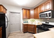 Thumbnail 14 of 19 - Clubhouse Kitchen with Stainless Steel Appliances at Ashmore Trace