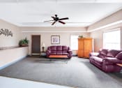 Thumbnail 4 of 13 - Clubhouse lounge at Carriage House Apartments in New Albany, featuring comfortable seating.