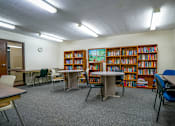 Thumbnail 10 of 15 - Clubhouse at Wesley Park Apartments, featuring a spacious interior with comfortable seating areas and bookshelves with books.