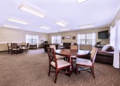 Thumbnail 4 of 16 - Community clubhouse at Cambridge Square Apartments in Greenwood, featuring comfortable seating areas, and spaces for social gatherings.