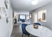 Thumbnail 7 of 39 - Dining and living room in a 2-bedroom, 1-bath apartment at Woods of Fairfax, featuring an open layout and modern furniture.