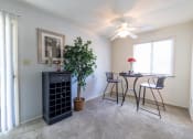 Thumbnail 16 of 23 - Dining room with a window and patio access at Woodbridge Apartments