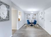 Thumbnail 9 of 39 - Dining room in a 2-bedroom, 1-bath apartment at Woods of Fairfax, featuring a modern table and seating.