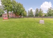 Thumbnail 6 of 21 - Dog park with bench seating at Ashley Pointe Apartments