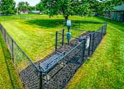 Thumbnail 8 of 15 - Dog park at Wesley Park Apartments, featuring a spacious, fenced area for pets to play.