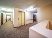 Thumbnail 5 of 15 - A hallway with an elevator at Wesley Park Apartments, providing convenient access to all floors.