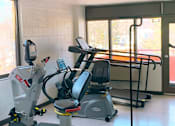 Thumbnail 4 of 13 - Fitness center with cardio equipment at Marshall House Apartments.