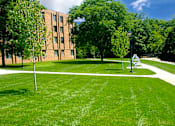Thumbnail 12 of 13 - Exterior view of Marshall House Apartments showcasing well-maintained surroundings.