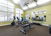 Thumbnail 8 of 27 - A spacious home gym with a variety of exercise equipment.