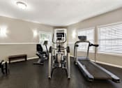 Thumbnail 12 of 24 - Fitness center at Briarwood Apartments, Columbus, IN, with cardio exercise equipment.