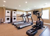 Thumbnail 16 of 27 - Fitness Center at Archer's Pointe with treadmills, elliptical machine and washer and dryer sets.