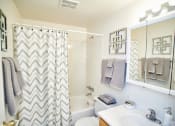 Thumbnail 4 of 19 - Bathroom at Ashmore Trace with Vanity, Toilet, and Shower.