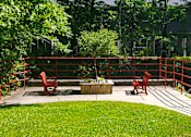 Thumbnail 7 of 13 - Charming garden patio at Marshall House Apartments with lush greenery and outdoor seating for relaxation.