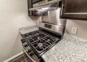 Thumbnail 3 of 63 - Gas Stove at Woodbridge Apartments Bloomington