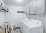 Thumbnail 18 of 39 - In-unit laundry room in a 2-bedroom, 1-bath apartment at Woods of Fairfax, featuring a washer and dryer.