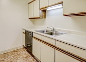 Thumbnail 2 of 18 - Kitchen with cabinets at Thompson Village Apartments, Indianapolis, IN, 46227
