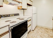 Thumbnail 1 of 18 - Kitchen with appliances at Thompson Village Apartments, Indianapolis
