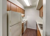Thumbnail 16 of 21 - Kitchen with white appliances and lots of cabinets at Ashley Pointe Apartments