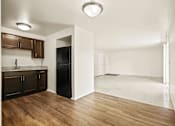 Thumbnail 3 of 15 - Kitchen and living room in a 2-bedroom, 1-bath apartment at Cambridge Square Apartments in Flint.