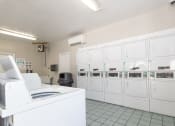 Thumbnail 8 of 63 - Laundry facility at Woodbridge Apartments Bloomington