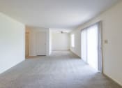 Thumbnail 18 of 23 - Living and dining room with patio access in the 2 bedroom apartment at Woodbridge Apartments