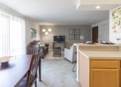 Thumbnail 6 of 19 - Open Living and Dining Room with Patio Access in a One Bedroom Apartment  at Ashmore Trace