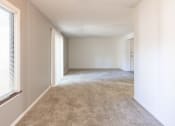 Thumbnail 11 of 12 - Open living and dining space with patio access in a 2 Bedroom Apartment  at Woodlake Apartments