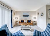 Thumbnail 6 of 39 - Living room in a 2-bedroom, 1-bath apartment at Woods of Fairfax, offering seating and contemporary furnishings.