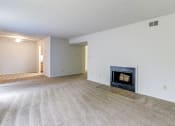 Thumbnail 9 of 21 - Living space at Ashley Pointe Apartments with a wood burning fireplace