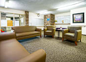 Thumbnail 7 of 15 - Mailroom lounge at Wesley Park Apartments, offering a comfortable space with seating and convenient access to mail and packages.