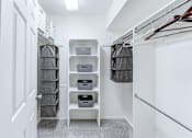 Thumbnail 13 of 39 - Master closet in a 2-bedroom, 1-bath apartment at Woods of Fairfax, featuring spacious hanging space and shelving.