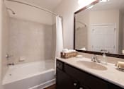 Thumbnail 21 of 27 - A bathroom with a white tub and sink.