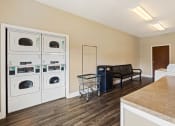 Thumbnail 17 of 18 - Onsite laundry facility at Briarwood Apartments in Lafayette, featuring washers and dryers.