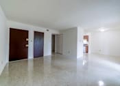 Thumbnail 13 of 15 - A large empty room with a wooden floor and white walls.