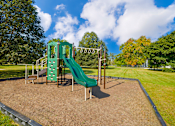 Thumbnail 10 of 15 - Playground at Cambridge Square Apartments in Flint, featuring colorful play structures.