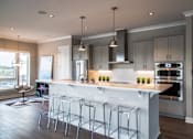 Thumbnail 14 of 41 - Luxury Penthouse Kitchen With Stainless Steel Appliances and Modern Cabinets at Quarry at River North Apartments, Indiana 46240
